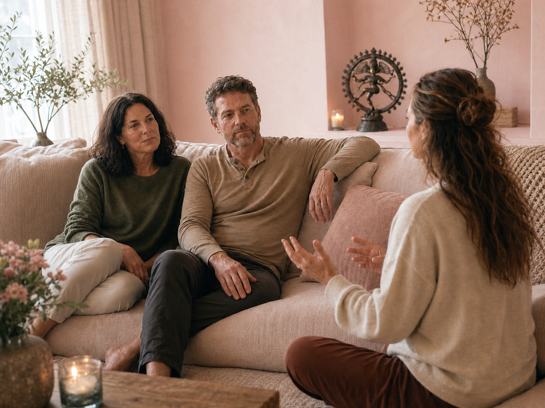 Couple receiving guidance in a pale blush-pink studio